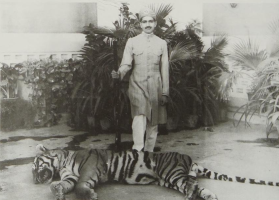Colonel H.H. The Maharaja Sawai Sir Tej Singh Prabhakar of Alwar is seen with a man-eating tiger he shot down