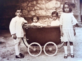 Karni Singh and his sister Sushila Kumari are seen with their younger sibling Amar Singh and cousin Jaya Kumari both seated in their perambulator (Bikaner)