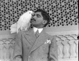 Maharaj Bijey Singh with a white cockatoo on his shoulder