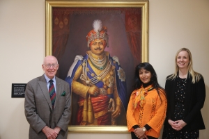 Baiji Lal Divya Kunverba at Millfield School in front of the portrait of her grandfather H.H. Sir Ghanshyamsinhji Ajitsinhji (Dhrangadhra)