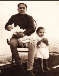 Maharawat Sahab Karan Singhji with Kunwar Pratap Singhji (standing) and Kunwar Digvijay Singhji in his lap