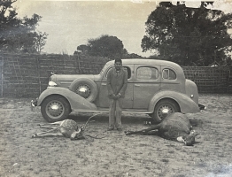 Maharaj Lal Hari Sharan Singh Ji Deo standing with his hunt, beside a vintage car at Ramanuj Vilas Palace Korea