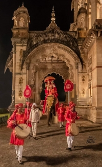 Kunwar Raj Ratna Pratap Deo arriving at Luxmi Vilas on an elephant waving at the excited crowd who is welcoming the bridegroom in big numbers.