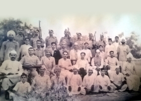 Raja Saheb Brijendra Singh Ju Deo sitting in centre with hat on his lap, and others with Tori Fatehpur State Police at his own Fort Tori Fatehpur.